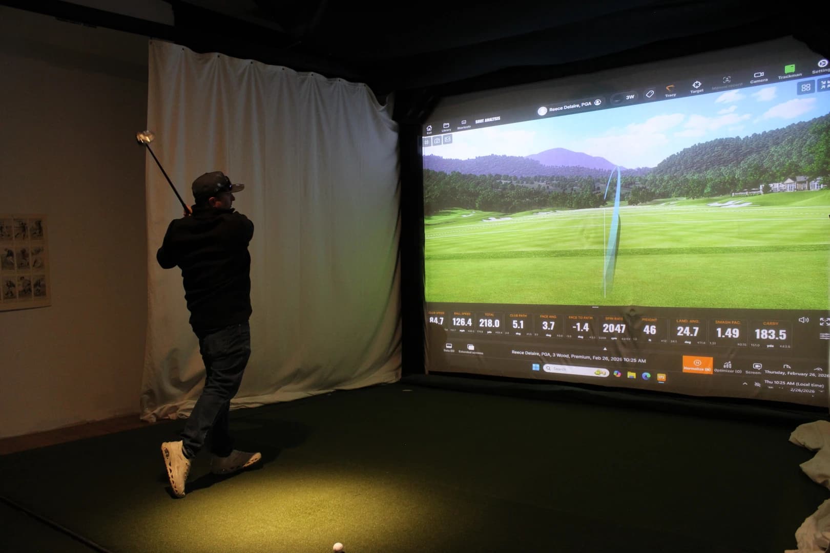 TrackMan simulator showing real-time shot data overlay