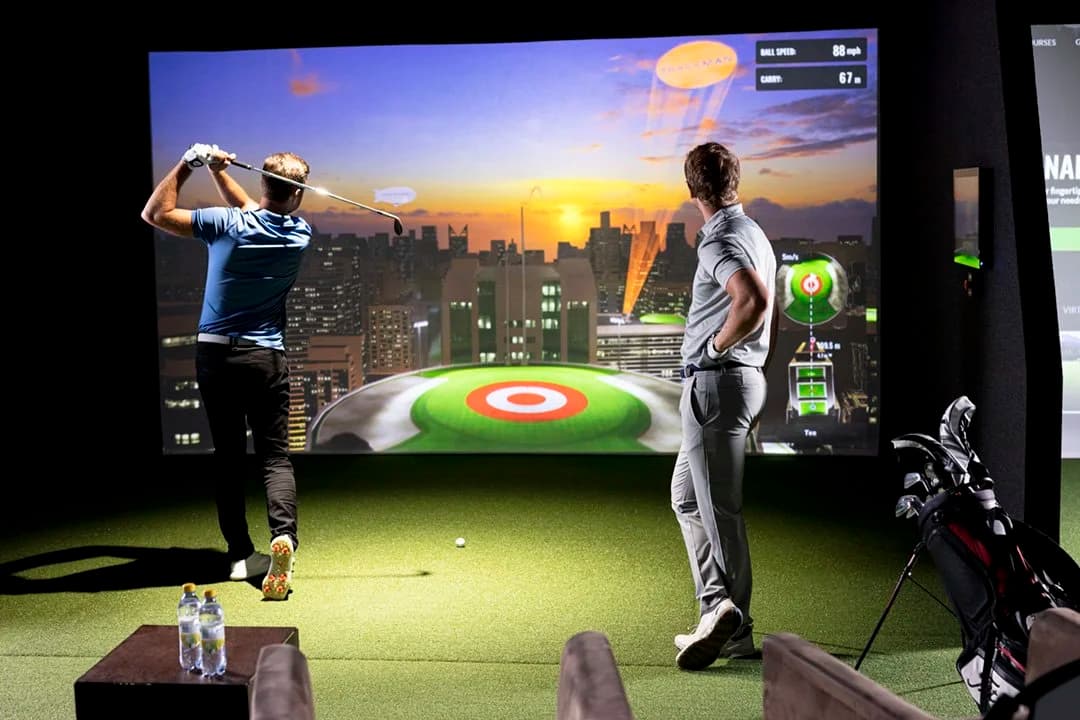 Players competing in Bullseye game on TrackMan simulator