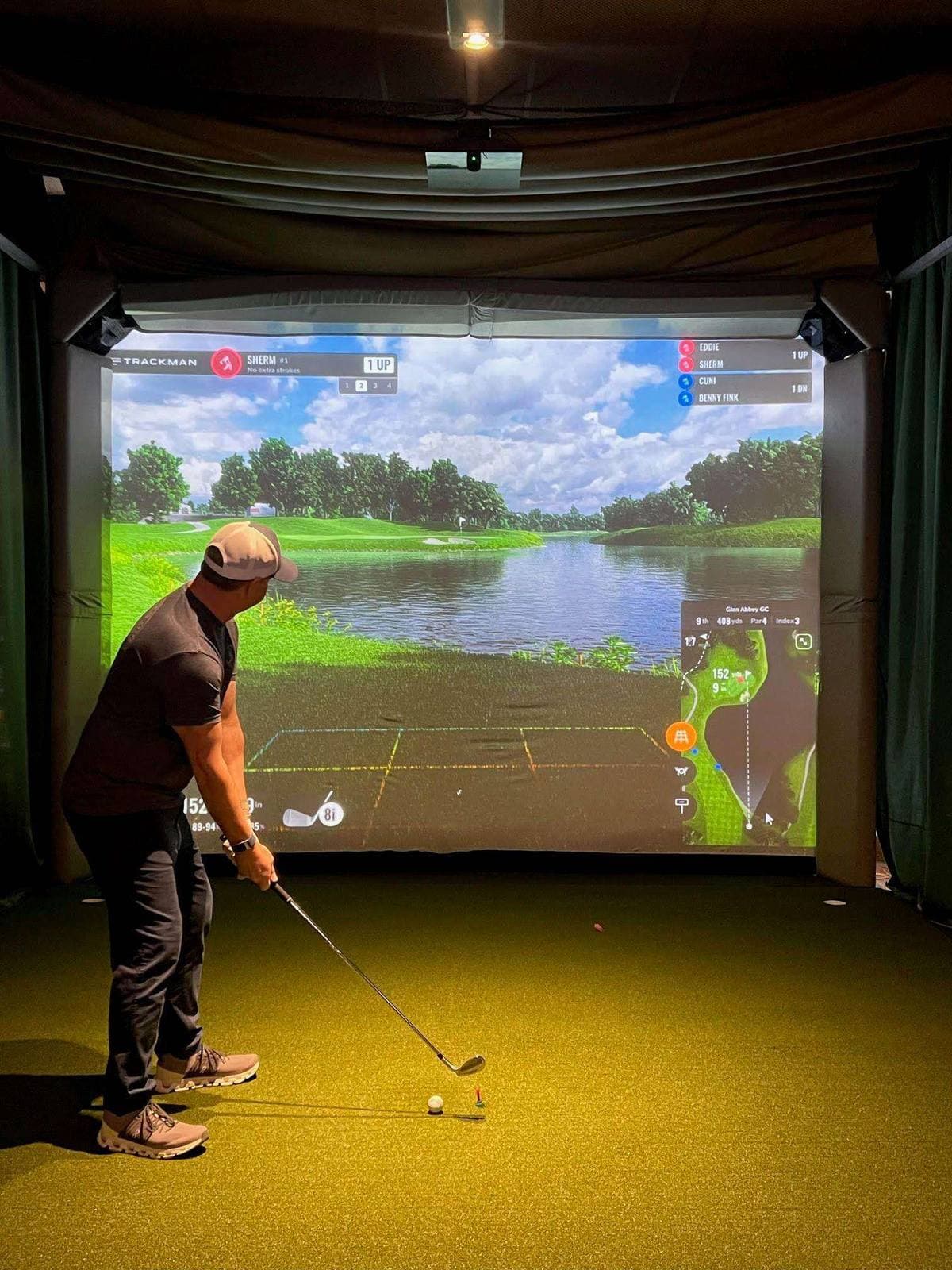 Golfer addressing ball in TrackMan bay — what you see with your eyes